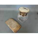A silver card case and a silver top bottle with ivory insert decorated with a dragonfly,