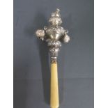 A silver child's rattle whistle and teether - two bells missing and wear