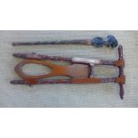 A mahogany Victorian boot jack and an African walking stick
