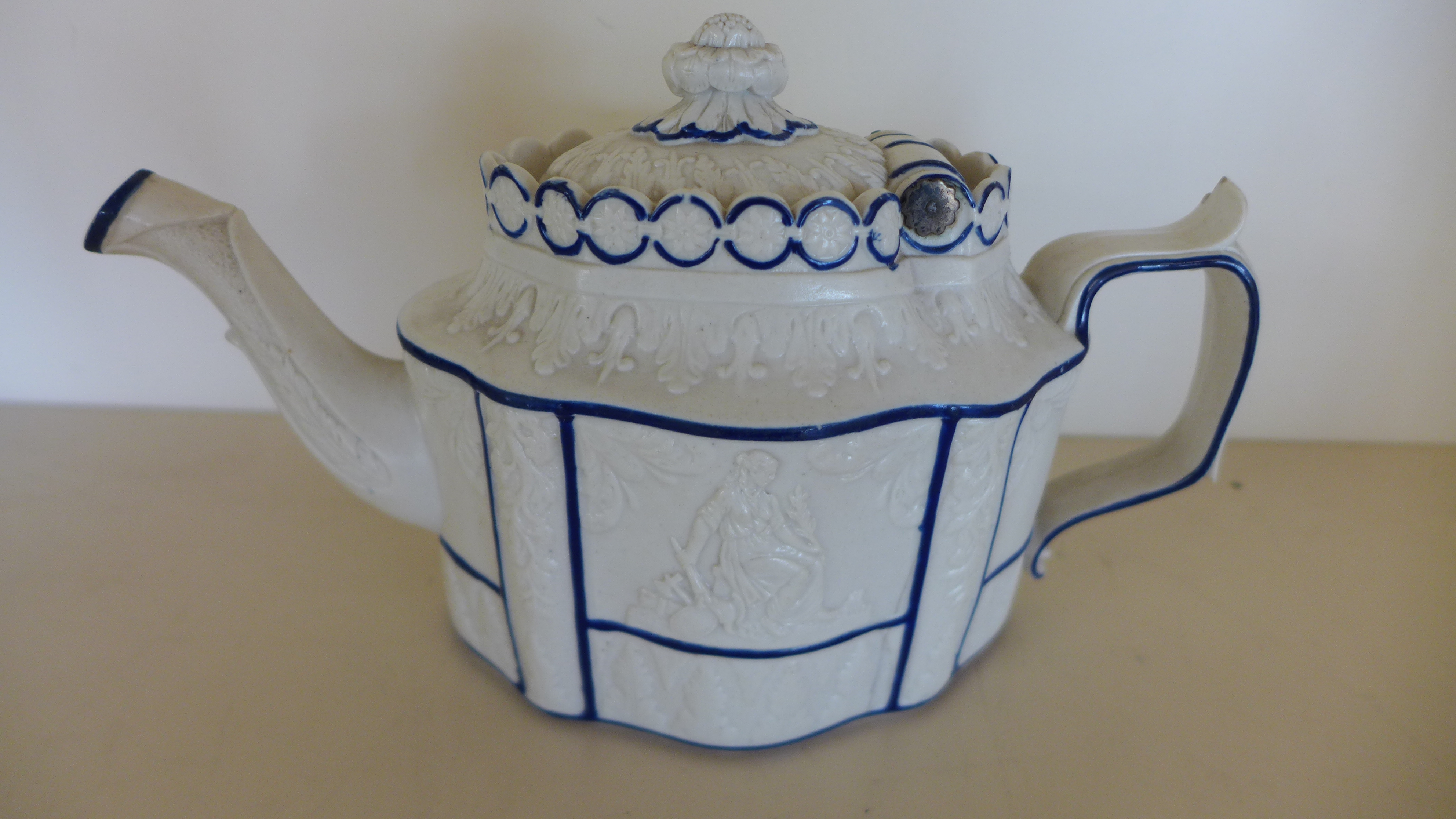 A 19th century Castleford type teapot with hinged cover and classical decoration - crack to body,