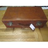 A vintage leather suitcase with old travel stickers - general travel wear Provenance: Sherford