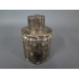 A silver hallmarked circular tea canister with Art Nouveau embossed design Sheffield 1904-05 -