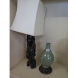 A Celadon bottle vase on a wooden stand - Height 31cm - drilled for table lamp fitting,