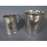 A silver tankard Walker and Hall Sheffield 1857 - maker JEB - Height 7cm - dented - and a silver