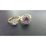 Two 9ct gold cluster rings - To include amethyst and white-gem,