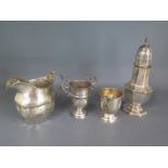 Four pieces of silver all with dents or damage to include a sifter,