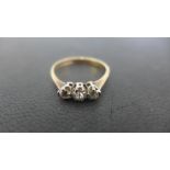 A 9ct yellow gold three stone diamond ring size O,