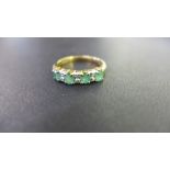 A 9ct gold emerald and diamond half-circle ring - Hallmarked Sheffield - Ring size P 1/2 - Weight