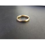 An 18ct gold band ring - Hallmarked London - Ring size M - Weight approx 3.