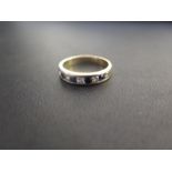 An sapphire and white-gem channel-set ring - With foreign marks,