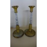 A pair of ormolu and glass candle sticks - Height 32cm - both have chips to base of glass,
