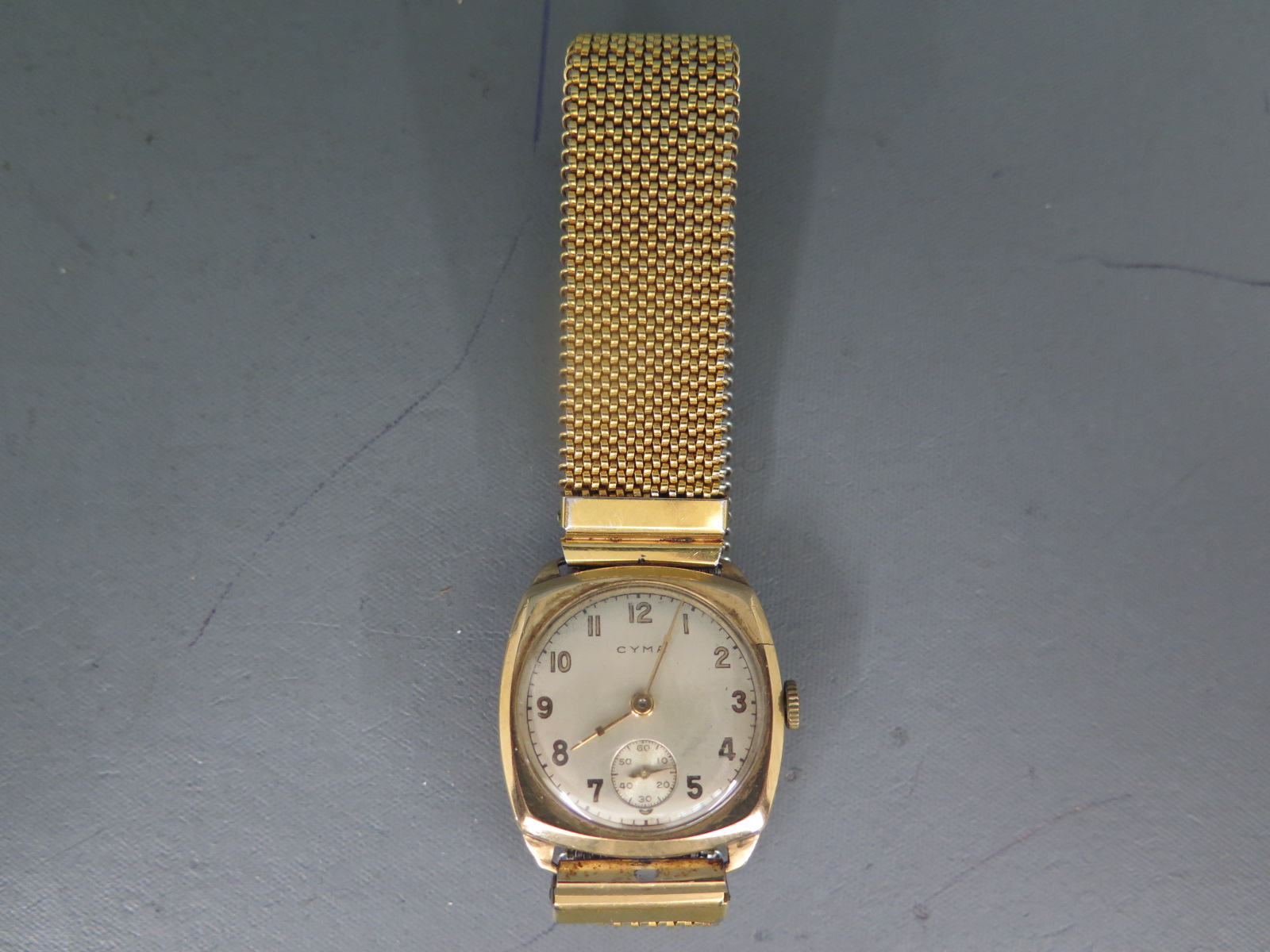 A 9ct yellow gold cased Cyma wristwatch with champagne coloured dial with Arabic numerals,