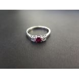 A platinum ruby and diamond three-stone ring - Estimated total diamond weight 0.