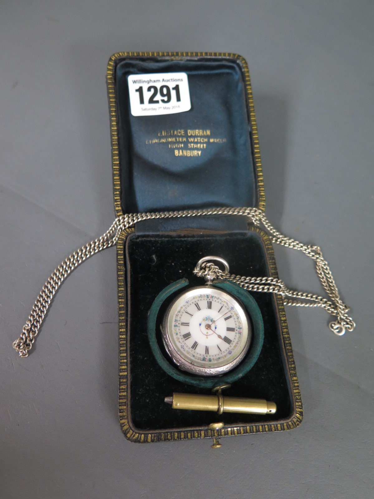 A silver pocket watch Eustace Durran with a chain and a brass pencil - working,