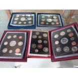 Five Royal Mint coin proof sets