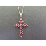 A 14ct gold garnet cross - Hallmark obscured - Length 3.8cms - Weight approx 2.