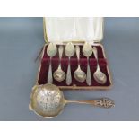 A cased set of silver hallmarked teaspoons and a silver hallmarked strainer spoon 1950 and 1953