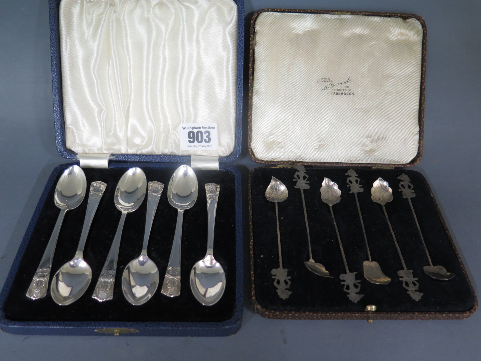 A boxed set of six silver 1910-1935 commemorative tea spoons and a boxed set of Eastern silver