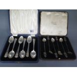 A boxed set of six silver 1910-1935 commemorative tea spoons and a boxed set of Eastern silver
