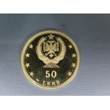 An Albanian 50 Leke gold coin approx weight 9.9 grams .