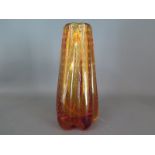 A tangerine, amber coloured lobed glass vase,