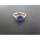 An 18ct yellow gold ring with sapphire and six small diamonds to centre - size O