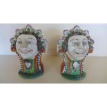 A pair of 19th century Staffordshire window rests modelled as two smiling ladies faces above a rams