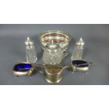 A pair of silver hallmarked salts with blue glass liners,