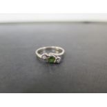 A tourmaline and diamond three-stone crossover ring - Tests as 9ct gold - Ring size M - Weight