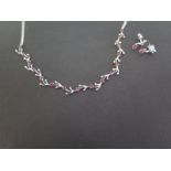 A ruby foliate necklace - To the belcher-link chain - Stamped 750 - Length 46cms - Together with a