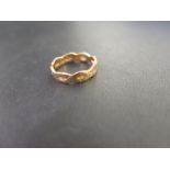 A 22ct gold textured twist ring - Of openwork design with textured detail - Hallmarked London -