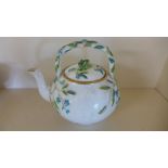 A 19th century teapot with floral decoration and branch handle lozenge mark - Height 15cm - crack