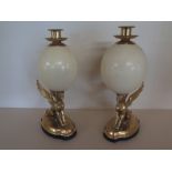 A pair of Ostrich egg candlesticks on gilt sphinx supports and ebonised bases - Height 34cm - both