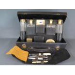 A good quality French leather cased travelling vanity case fitted with gilt metal topped bottles