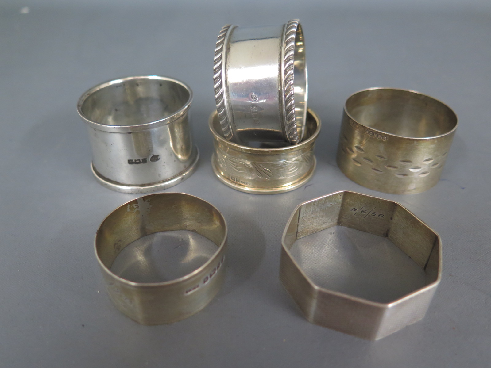 Six silver napkin rings - varying condition - approx weight 3.