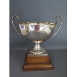 A silver presentation twin handled bowl on wooden stand London 1913/14 TB&S - Height 23cm approx