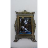 A 19th century Continental school convex enamel of a priest praying before a crucifix in a gilt