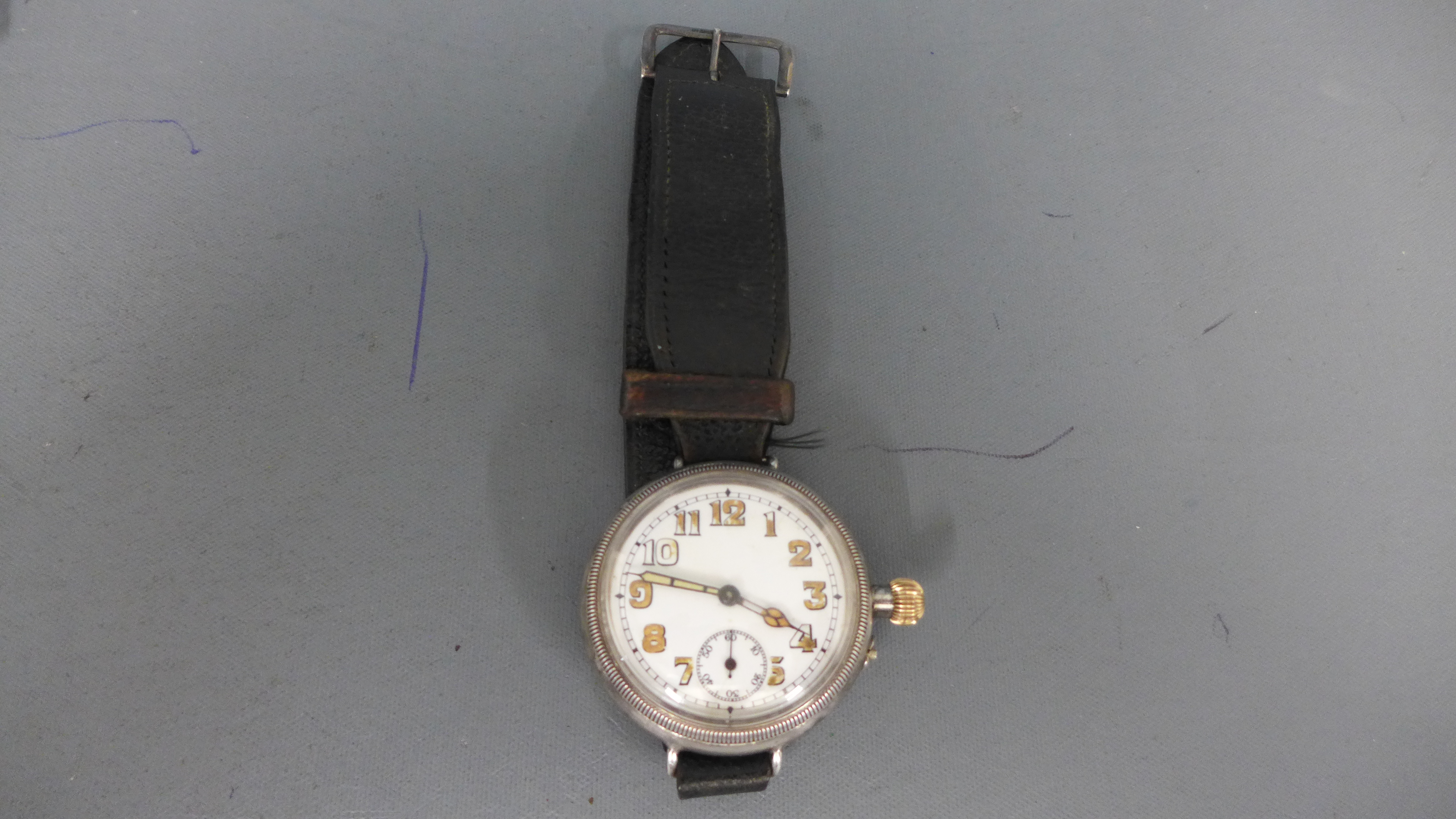 A World War One silver cased trench watch with Arabic numerals to white enamel circular dial,