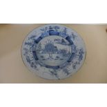 An 18th century Bristol Delft scenic plate - Diameter 28cm - multiple chips to rim Provenance: