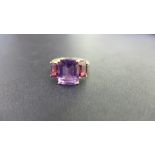 A 9ct gold amethyst three-stone ring - Hallmarked Birmingham - Ring size P 1/2 - Weight approx 2.