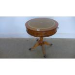 A modern yew wood effect drum table with an inset top and one active drawer - height 59cm x