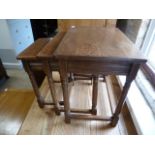 A nest of three oak side tables