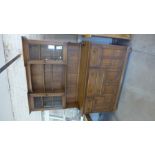 An Ercol elm dresser with a part glazed rack top above a four drawer,
