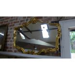 A modern ornate gilt framed mirror - 80cm x 104cm