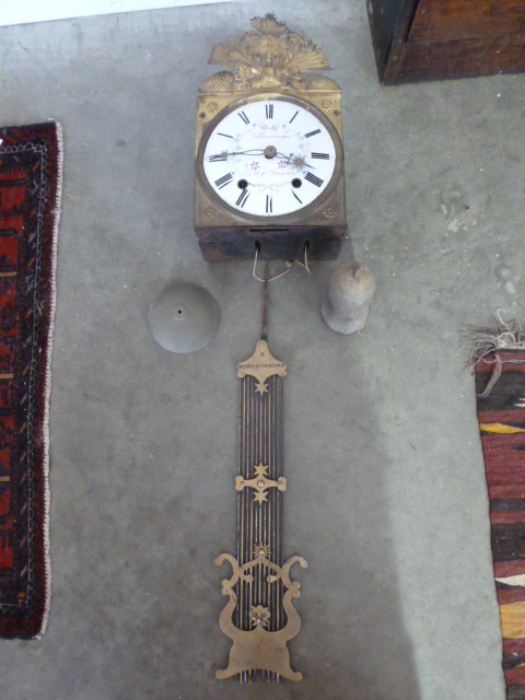 A French comtoise clock with a painted enamel dial,