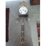 A French comtoise clock with a painted enamel dial,