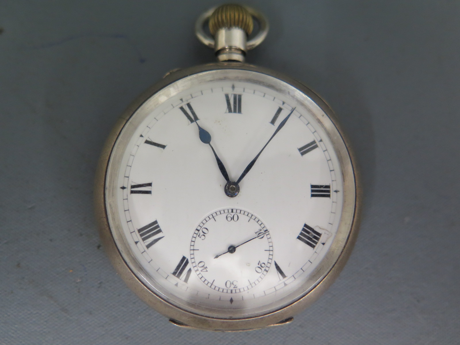 A silver cased open face pocket watch, white enamel dial with Roman numerals to chapter ring,