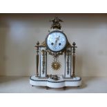 A good quality ormolu and marble portico drum clock with a decorated 10cm convex porcelain dial,