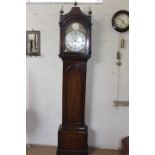 An 18th century oak and pine eight day striking longcase clock with a brass arched 12" dial and