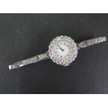 A Lady's manual wind watch with round white black Arabic dial unsigned,